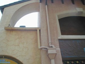 gutters and downspouts on cement stucco