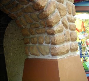 Base of stones is stucco