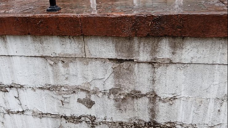 Water pouring out of wall