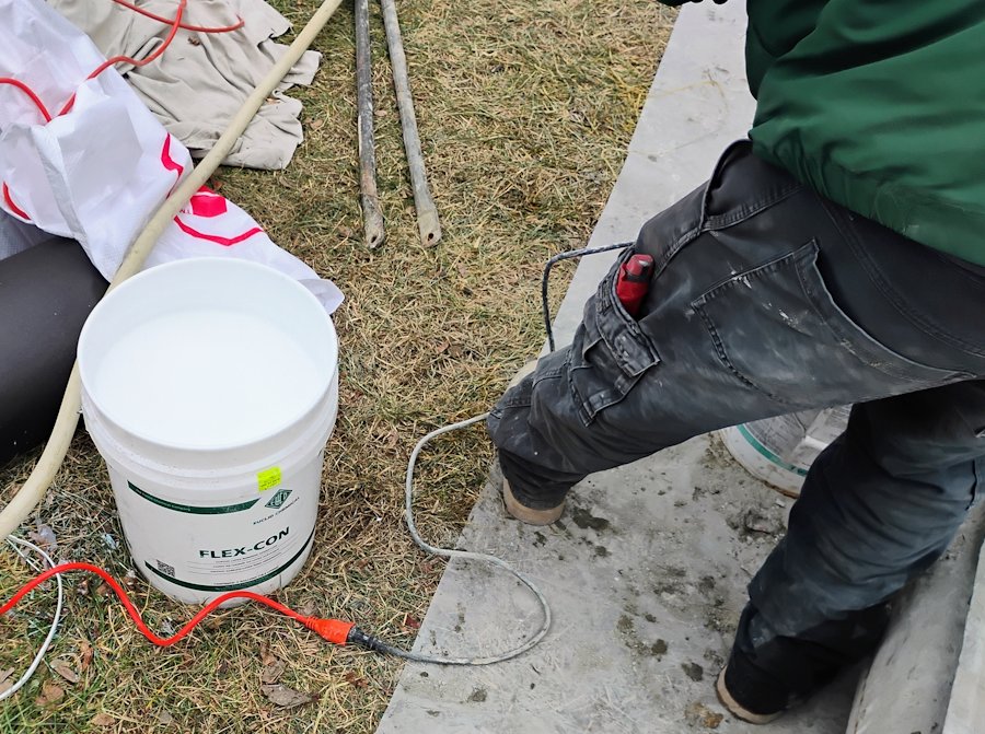 Mixing dry mix with flex con.