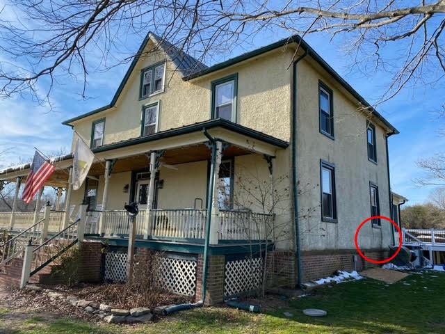 Bulge in old stucco house