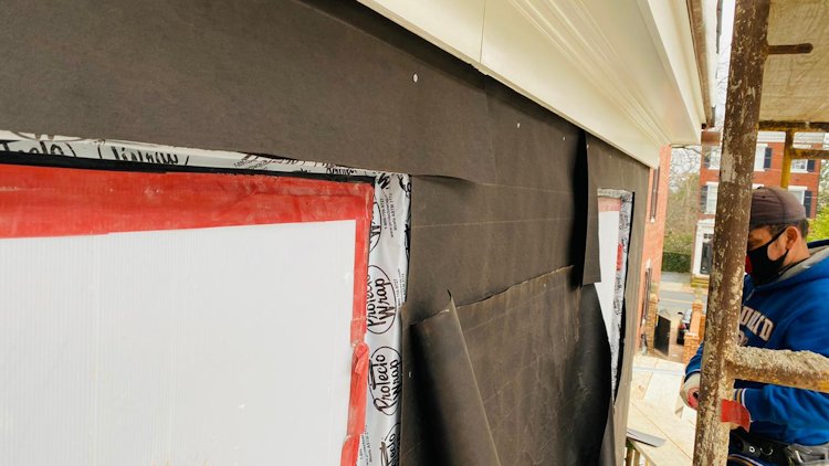 Tarpaper is put on from the bottom up.