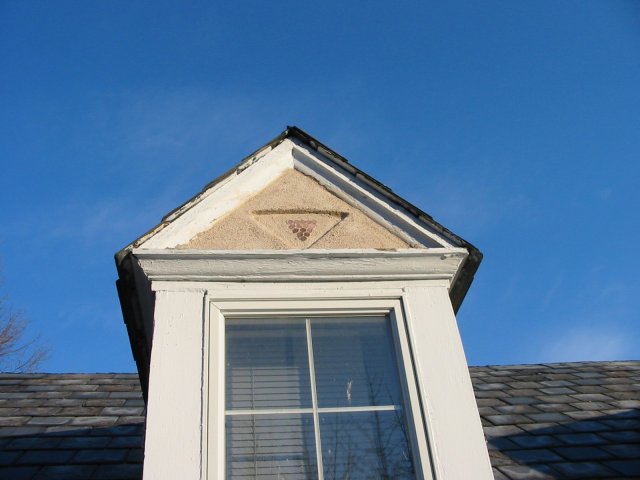 Triangles made of pennies are put on the dormers