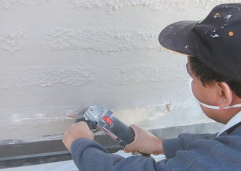 Stucco is cut off using a diamond blade