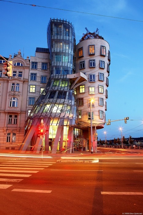 A spiral house with a green roof