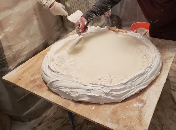 Mixing lime and gauging plaster on the mortar board..