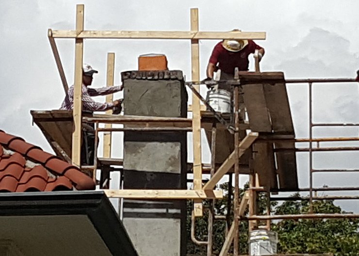 Stucco scaffold on this Spanish tile roof