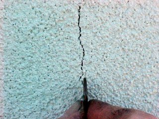 Major cracks on stucco panel