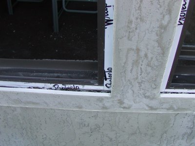 Badly out of square wall is trued up using screeds.